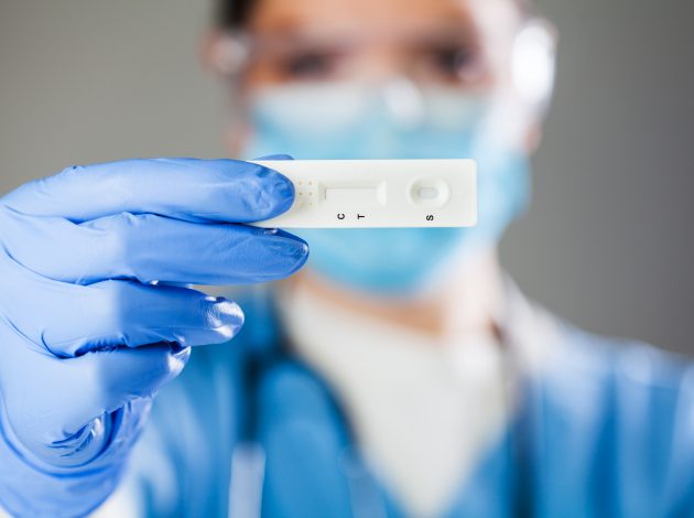 A nurse holding a Covid test