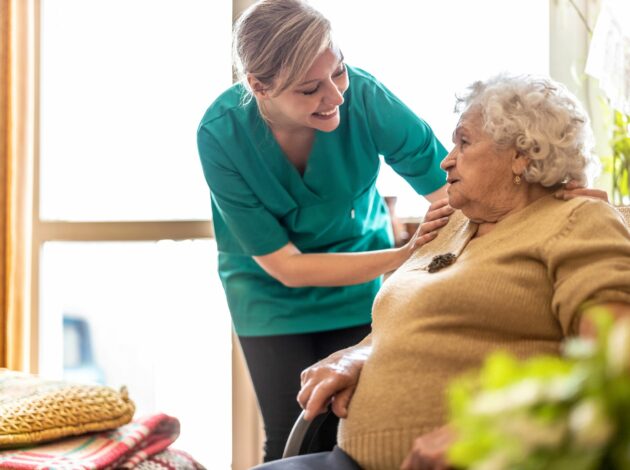 Friendly nurse supporting an elderly lady