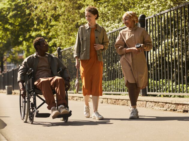 An image of three people in a park