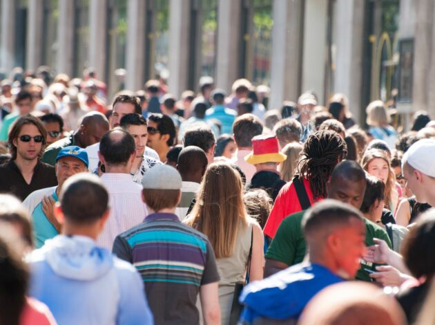 Crowds of people walking through the streets of London