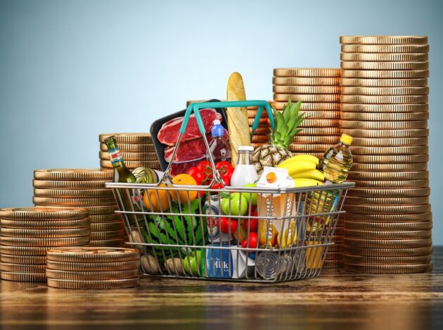 A shopping basket surrounded by stacks of coins